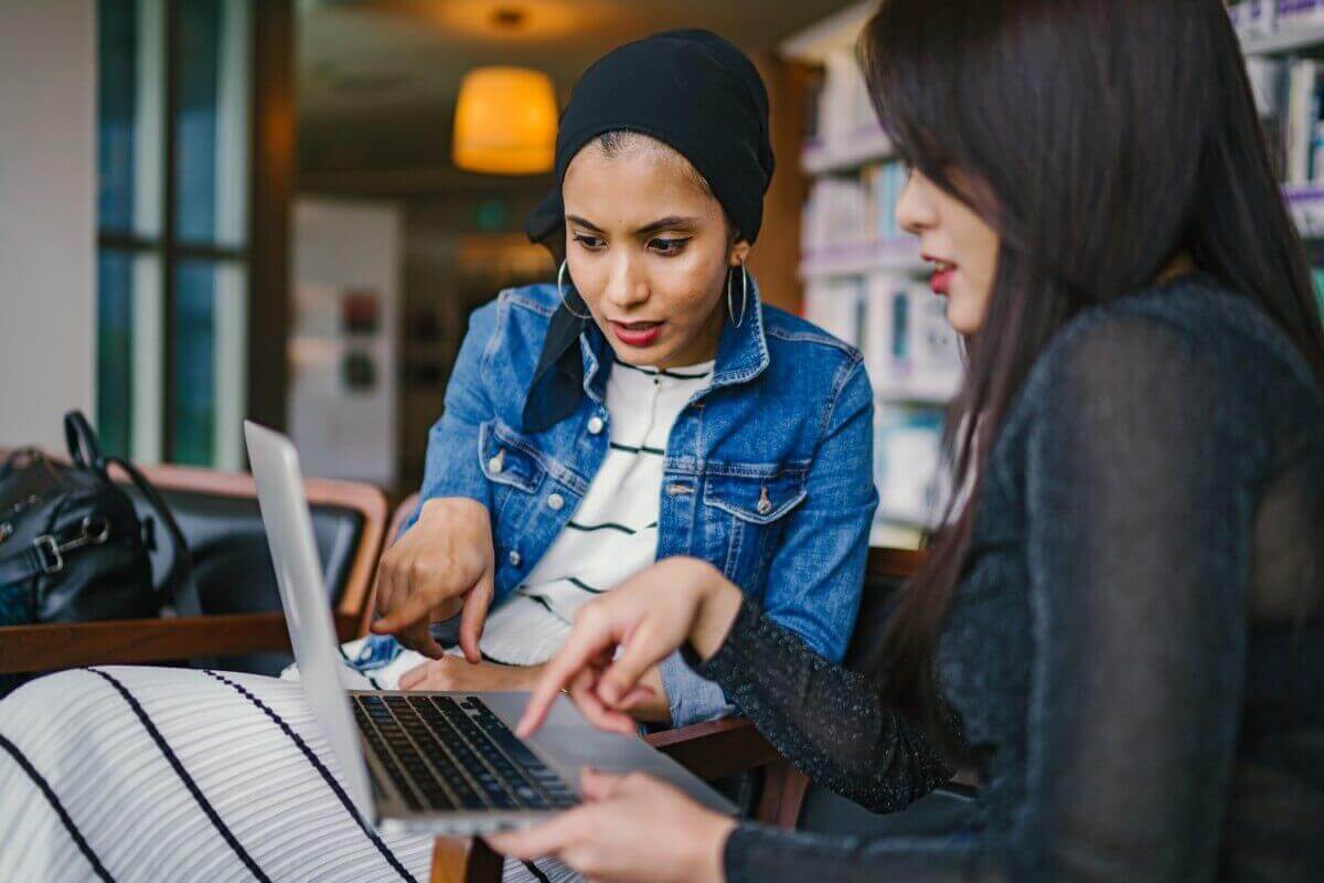 two women looking at a computer