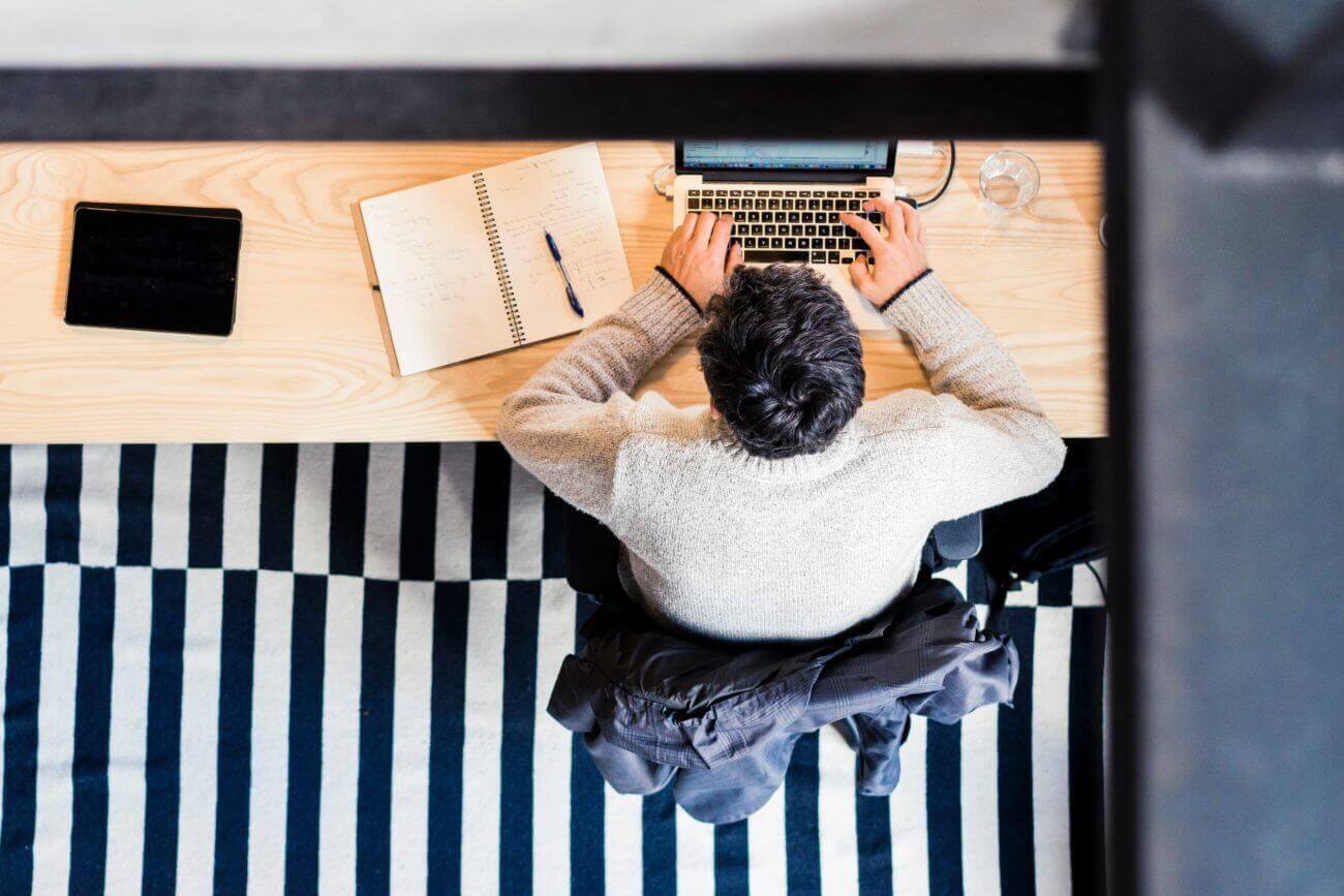 man typing on a computer at a desk