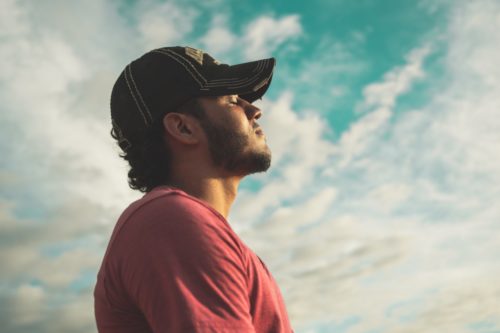 man looking out into the clouds