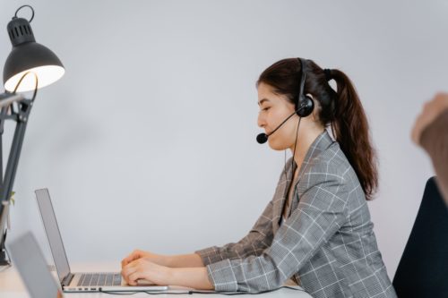 recruiter talking on a headset in an office