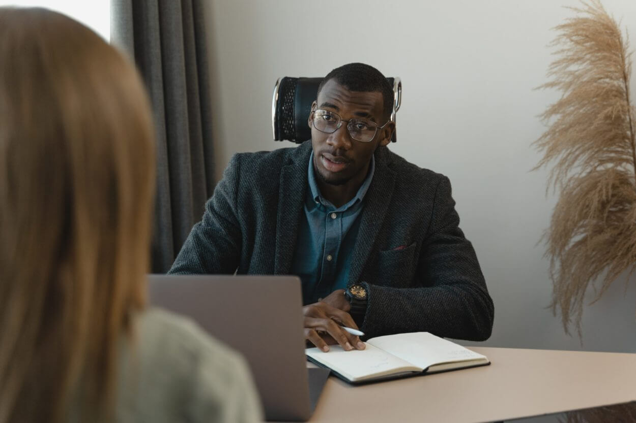 man interviewing a client at a desk