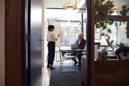 a man and a woman talking in an office