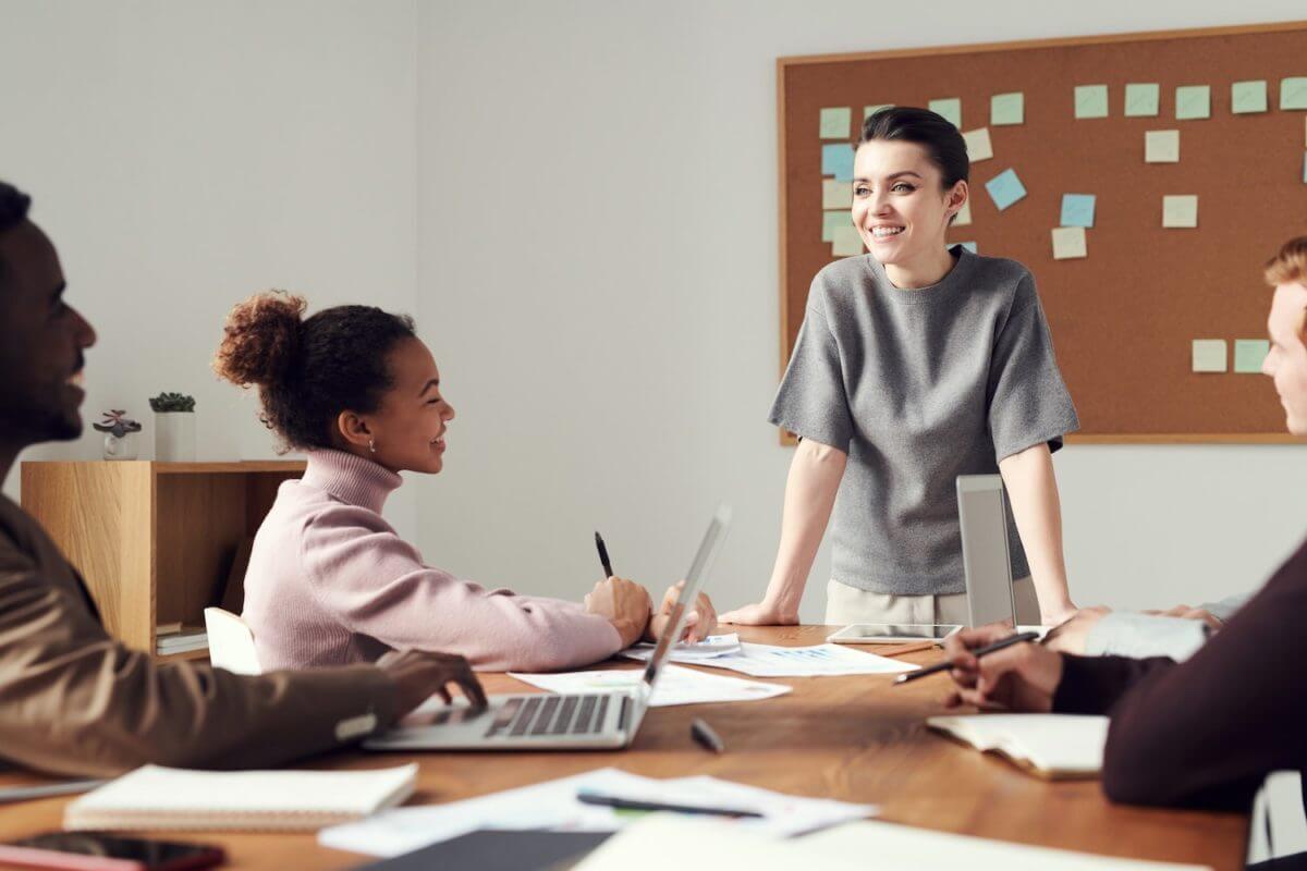 group of four people having a meeting