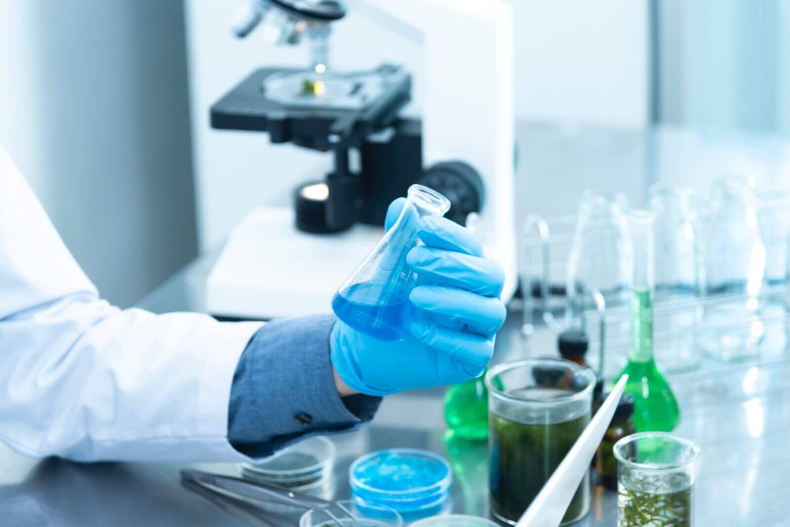 a person holding up a beaker full of chemicals in one of the most popular STEM jobs