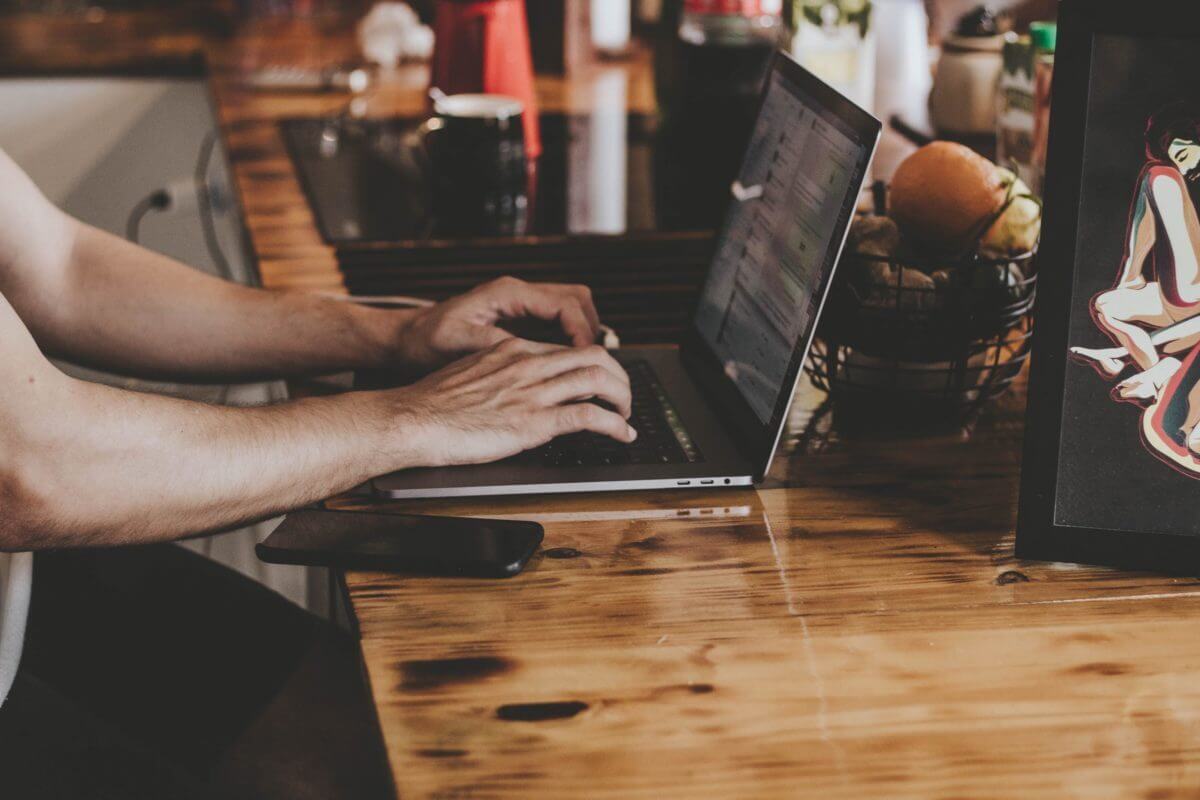 someone typing on a computer writing a cover letter
