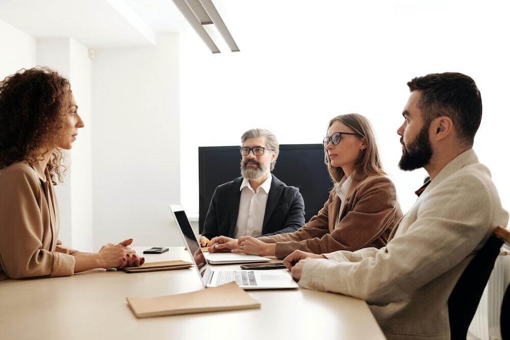 four people sitting in an interview