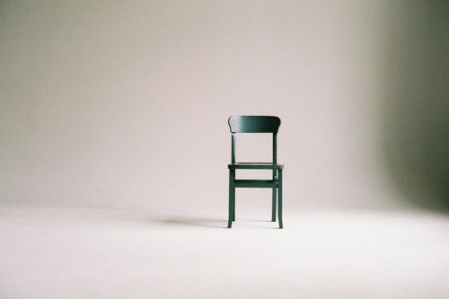 An empty chair in the middle of the room representing ghosting