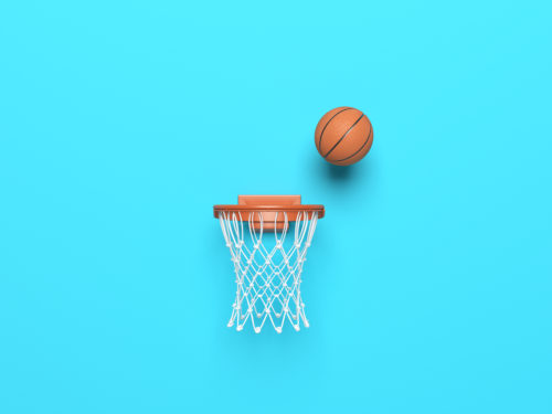 a successful basketball ball in the hoop on blue color background