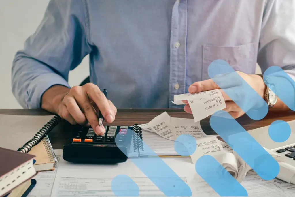 Executive at desk doing calculations with branding overlay.