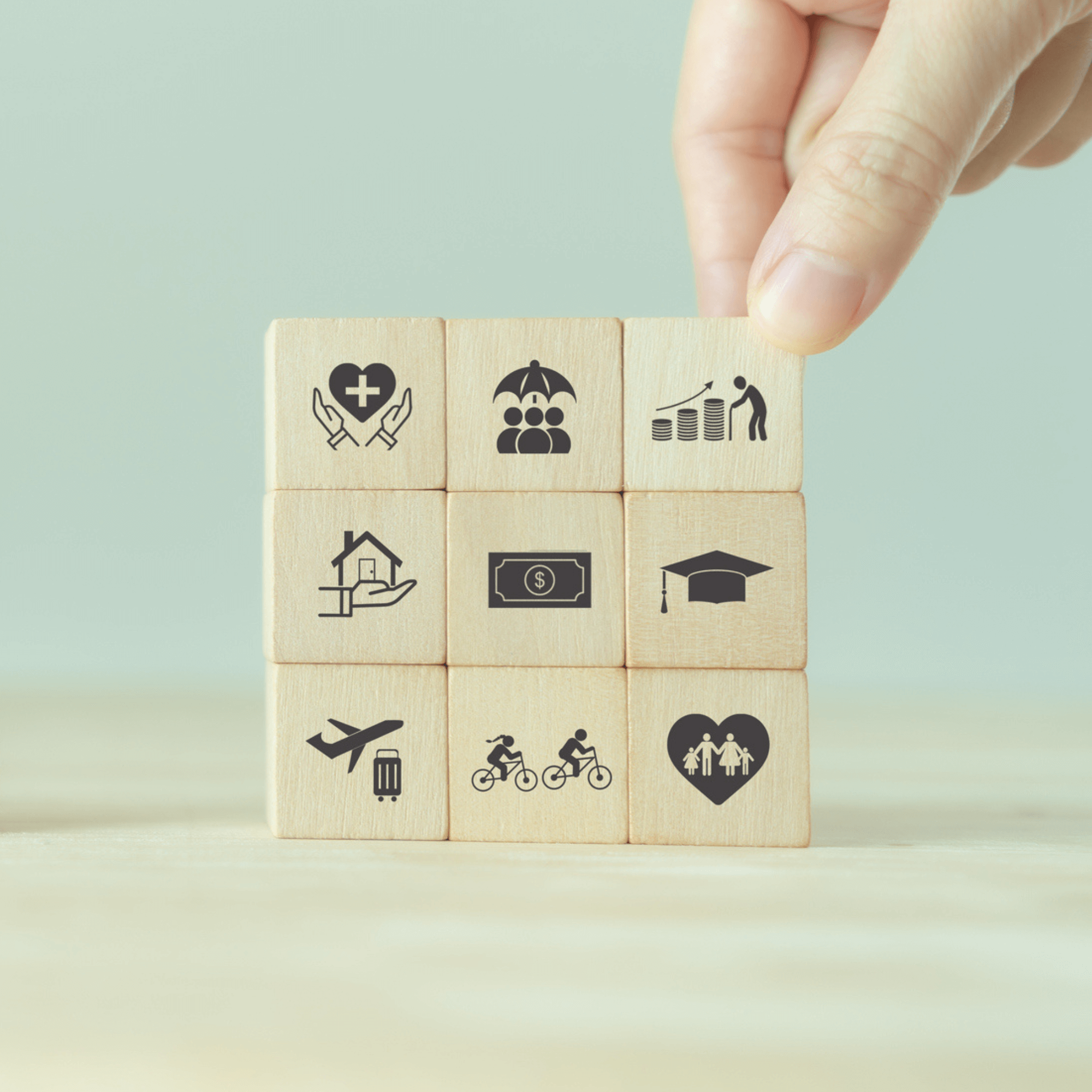 Wood blocks stacked 3 x 3 with images representing employee benefits.