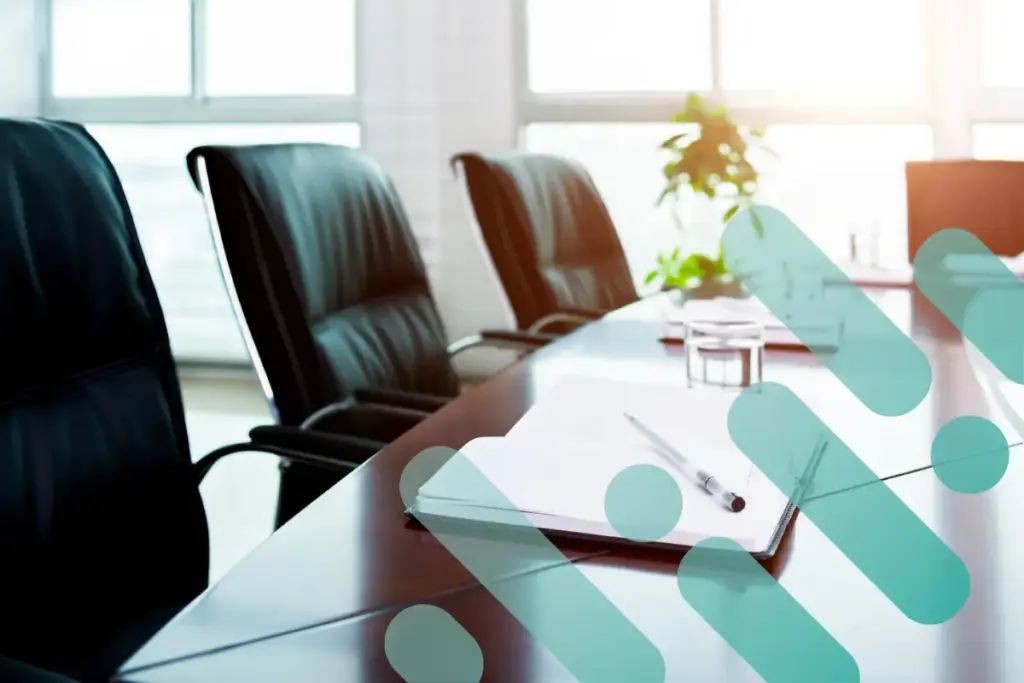 Board room with empty executive chairs and a notepad on the table with branding overlay.