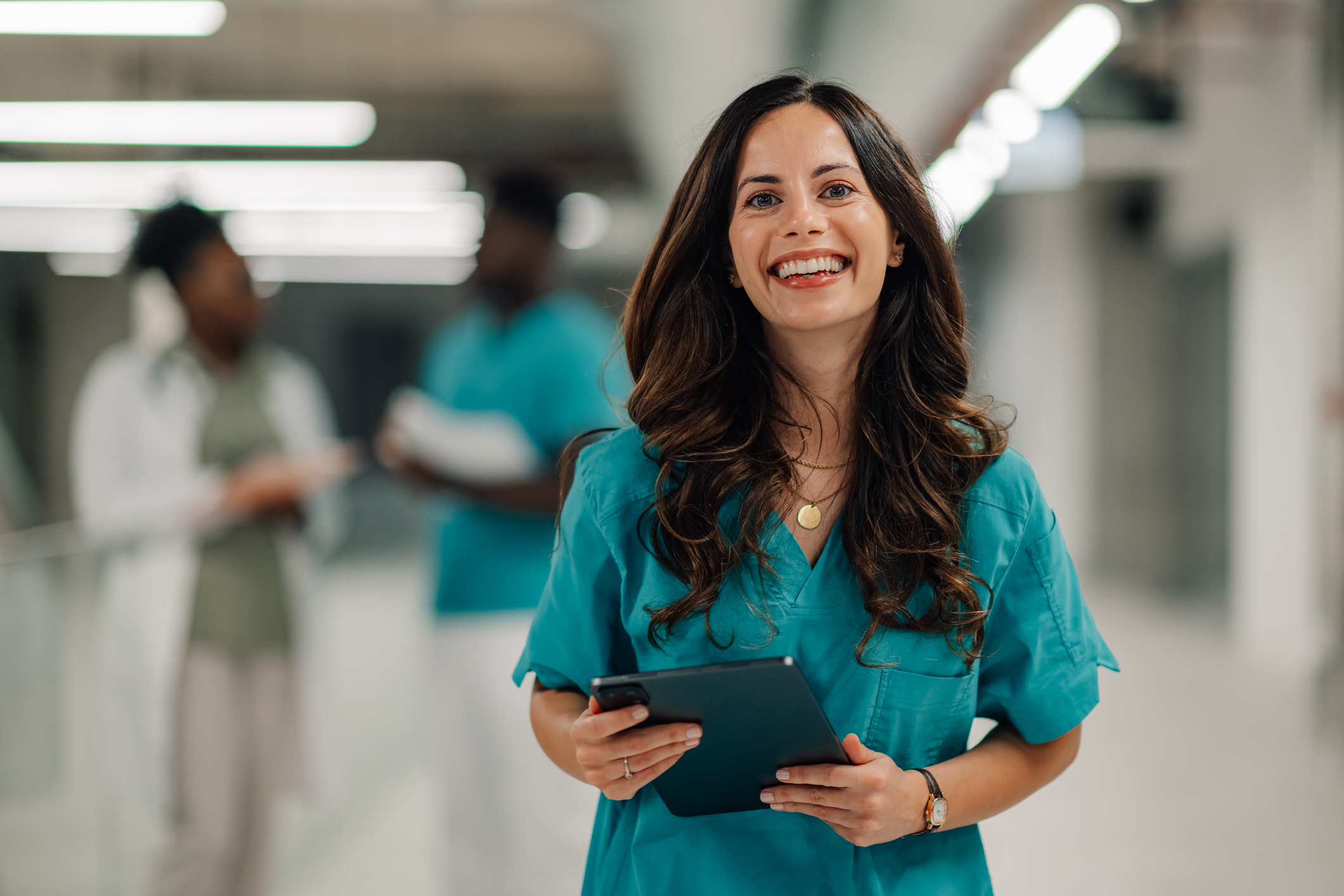 Confident female nurse holding digital tablet in hospital How AI Is Changing Healthcare Jobs