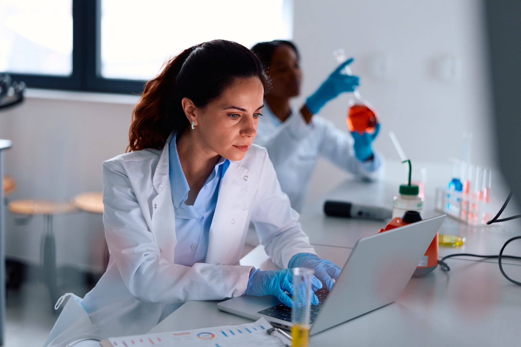 Woman scientist working on computer in laboratory Hiring Trends in Life Science: Critical Roles in Today’s Job Market